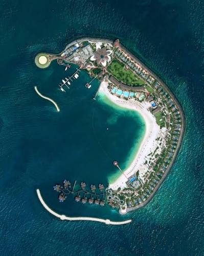 Banana Island from the air, with its beach, lagoon and villas over the water